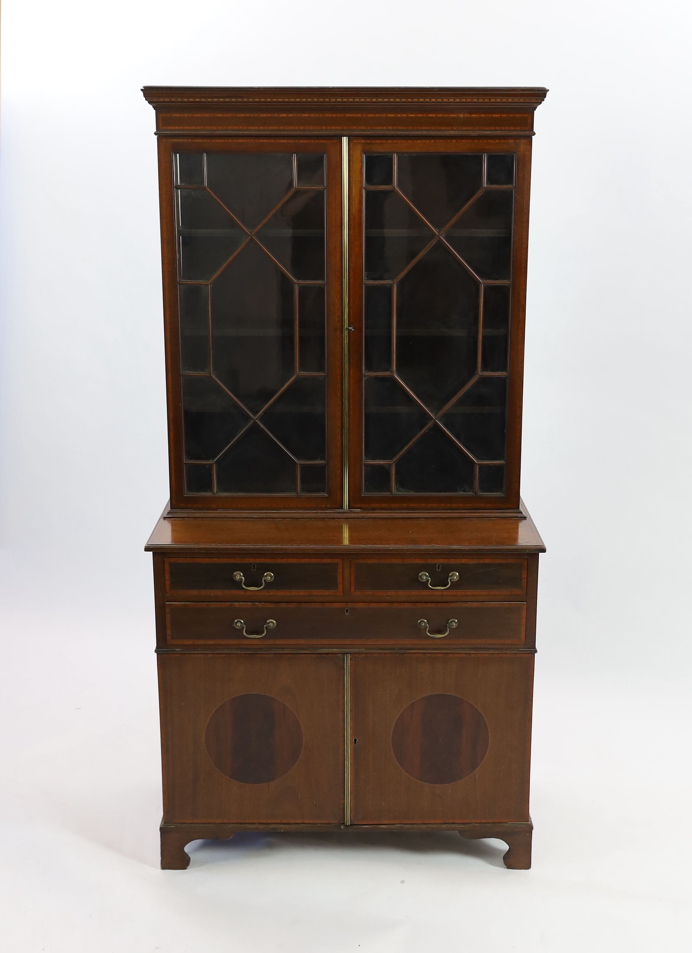 An Edwardian satinwood banded mahogany bookcase cupboard, fitted three drawers, width 91cm depth 50cm height 182cm